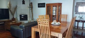 a living room with a table and a couch at Villa Ananda in Cilaos