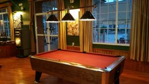 a pool table in a room with lights above it at Hotel Don Juan in Navalvillar de Pela