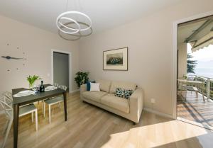a living room with a couch and a table at Vista Lago in Omegna +9 photos