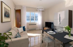 a living room with a couch and a table at Vista Lago in Omegna