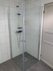 a shower with a glass door in a bathroom at Trysnes Brygge in Kristiansand