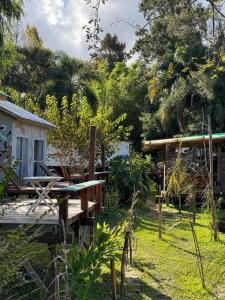 a garden with a wooden deck and a house at Lodge Gloria in Dique Luján