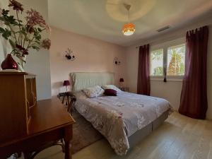 a bedroom with a bed and a desk and a window at Sublime Villa Climatisée Familiale avec Extérieurs Spacieux – Quartier Calme - FR-1-388-215 in Argelès-sur-Mer