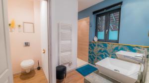 a bathroom with a sink and a toilet at La Grange des Anges in Blanc +50 photos