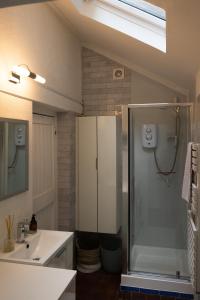a bathroom with a shower and a sink at Water View Cottage, Conwy in Conwy +29 photos