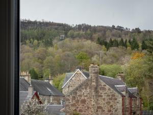 a group of houses in a village with trees at The Crags Hotel in Callander