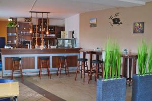 a bar in a restaurant with bar stools at Erbacher Hof in Homburg