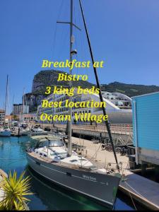 un barco atracado en un puerto deportivo con un cartel en él en LUXURY YACHT STAY "White Dove" sleeps 6 en Gibraltar