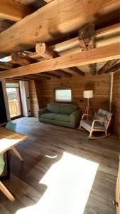 ein Wohnzimmer mit einer grünen Couch und einem Stuhl in der Unterkunft Chalet 181 Grand Haury in Arvier