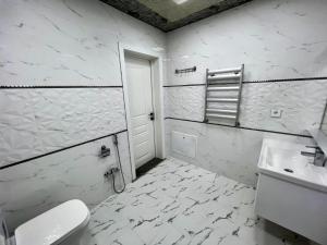 Un baño blanco con inodoro y lavabo. en White villa 4 bedrooms, en Gabala 12 fotos más