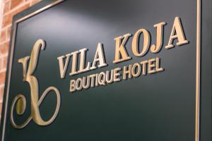 a sign for a vla koya boutique hotel at Vila Koja Boutique Hotel in Tirana