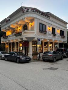 a building with cars parked in front of it at Vila Koja Boutique Hotel in Tirana +40 photos