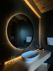 a bathroom with a large oval sink and a mirror at MOKHY Chalet & Nature in Vorokhta +88 photos