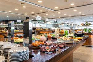 a buffet line with food on display in a restaurant at VS Gandía Palace Hotel **** in Gandía