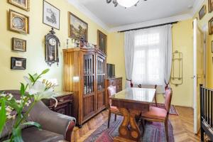 a living room with a table and a couch at Vámház Boulevard Apartments in Budapest