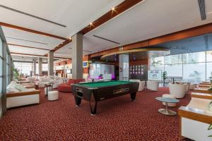 a pool table in a room with tables and chairs at VS Gandía Palace Hotel **** in Gandía