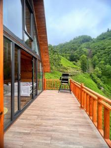 a wooden balcony with a view of a mountain at Northland Bungalows in Çayırdüzü