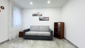 a living room with a chair and a window at Casa Venturini by Ca-Sa Check in Chioggia
