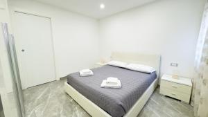 a bedroom with a bed with two towels on it at Casa Venturini by Ca-Sa Check in Chioggia