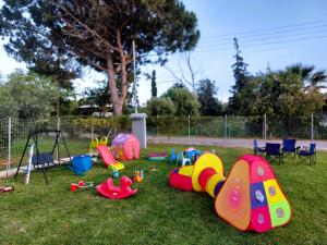 a playground with a bunch of toys on the grass at Chalkidiki Beach House in Nea Potidaea