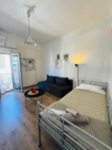 a bedroom with a large bed and a couch at Casa di Irene in Agios Rokkos