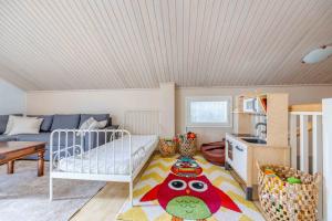 a childs room with a bed and a kitchen at Holiday Cabin Mäntyhovi in Kalajoki +37 photos