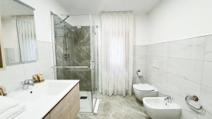 a bathroom with a shower and a sink and a toilet at Casa Venturini by Ca-Sa Check in Chioggia