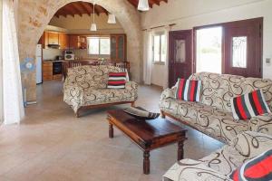 a living room with two couches and a coffee table at Villa Lianti in Pomos