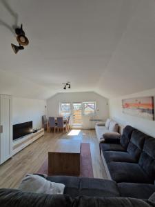 a living room with a couch and a table at Little Wish in Gdańsk