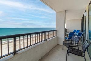 a balcony with chairs and a view of the beach at Seawinds, Oceanfront, 2 BR , Indoor Pool, Hot Tub in Myrtle Beach