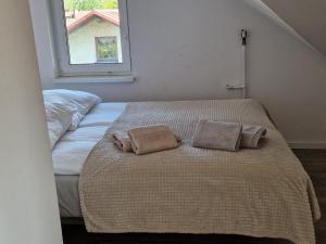 a bedroom with a bed with two pillows on it at Little Wish in Gdańsk