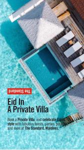 una portada de revista con una foto de una piscina en The Standard, Huruvalhi Maldives en Raa Atoll