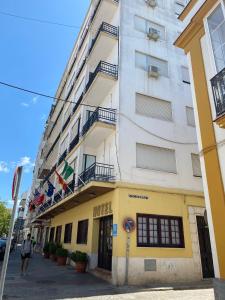 un edificio con banderas a un lado. en Hotel Medina Centro, en Jerez de la Frontera