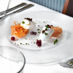 a white plate with food on a table at Albergo della Posta in Astano