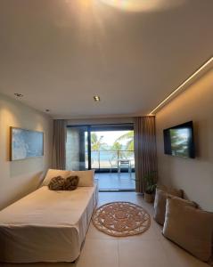 a bedroom with two beds and a balcony at Altamare - Pé na areia in Tambaú +140 photos