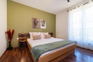 a bedroom with a large bed and a window at Apartments Villa SanMarino in Pakoštane