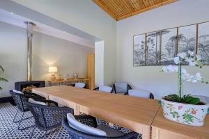 a room with a table and chairs and a fireplace at Almond Valley Manor House in Buffelskloof +47 photos