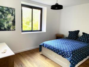 Postel nebo postele na pokoji v ubytování L'Auberge du Ranc