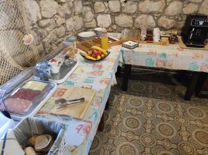 a table with a bowl of fruit on it at Apartman Karmela in Zaton