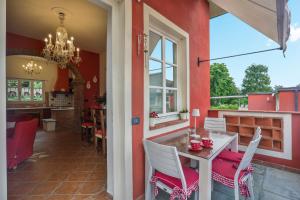 una sala da pranzo con pareti rosse e tavolo e sedie di POMODORO di Home Hill a Capannori