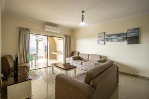 sala de estar con sofá y mesa en Saints View Resort Unit 17, en Uvongo Beach
