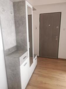 a room with a mirror and a dresser and a door at Sidus in Satu Mare