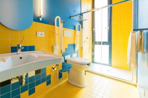 a bathroom with a toilet and a sink and a shower at The Match Hotel in Cervia