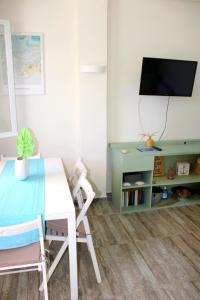 SERENITY yard apartment في بوروس: غرفة طعام مع طاولة وتلفزيون
