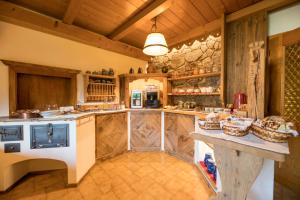 a large kitchen with wooden walls and wooden cabinets at B&B Seppi in Cavalese