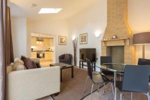 a living room with a couch and a table at Cambridge Water House Apartments in Cambridge