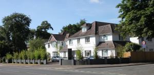 a white house on the side of a street at Remont Oxford Hotel in Oxford