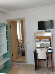 a room with a desk and a mirror and a bedroom at Flora Pansiyon Çıralı in Kemer