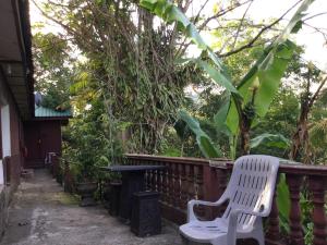a white chair and a table on a fence at D view hill hotel in Kuala Tahan