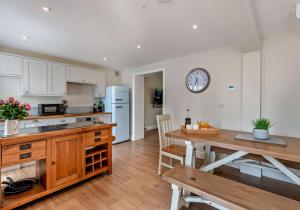a kitchen with a table and a dining room at City to Country Retreat Luxury Cottage with Hot Tub in Toppesfield